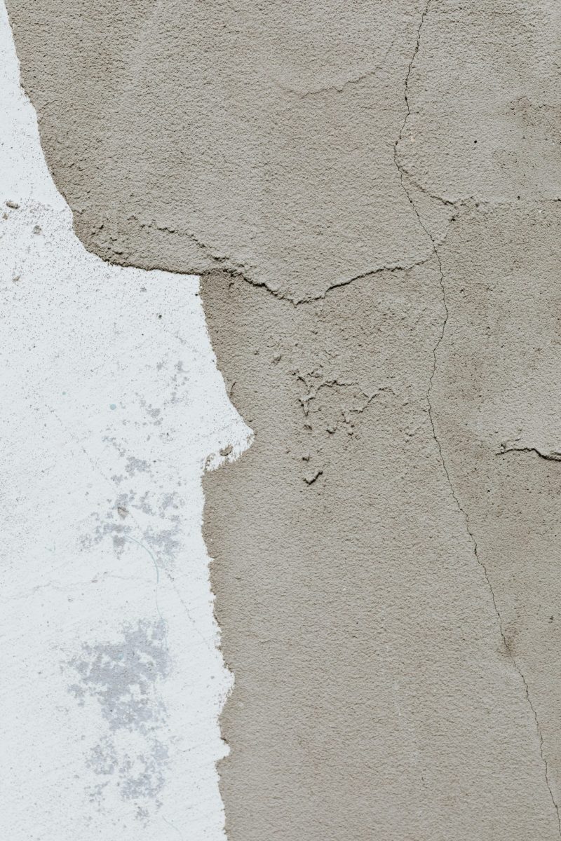 Close-up of cracked concrete showing artistic texture and wear.